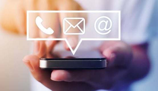 Close-up image of male hands using smartphone with icon telephone email mobile phone and address. Contact us connection and e-mail marketing concept